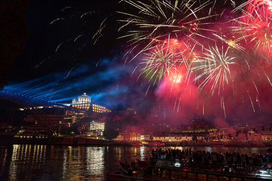 colorful beautiful fireworks over douro river in porto portugal on sao joao festival
