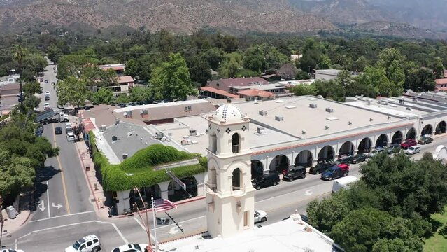 Aerial wide reverse pullback shot of charming downtown Ojai, California. 4K