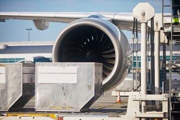 Preparation airplane at airport. Loading of cargo containers to plane. Selective focus on large jet...
