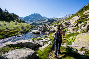 Naklejka premium Young hiker girl summit to Ratera Peak in Aiguestortes and Sant Maurici National Park, Spain
