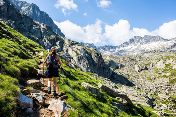 Fototapeta premium Young hiker girl summit to Ratera Peak in Aiguestortes and Sant Maurici National Park, Spain