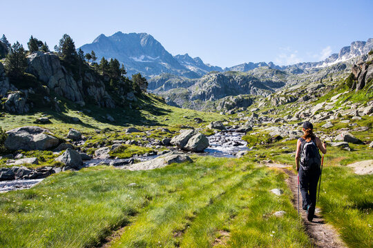 Young hiker girl summit to Ratera Peak in Aiguestortes and Sant Maurici National Park, Spain