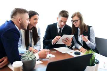 Young handsome man gesturing and discussing something while his coworkers listening to him sitting at the office table on a transparent background