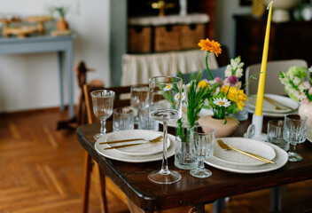 serving the table with fresh flowers and candles