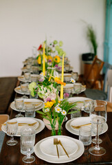 serving the table with fresh flowers and candles