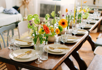 serving the table with fresh flowers and candles
