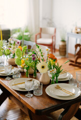 serving the table with fresh flowers and candles