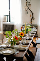 serving the table with fresh flowers and candles