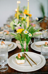 serving the table with fresh flowers and candles