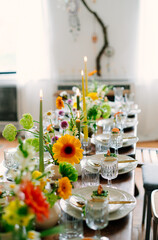 serving the table with fresh flowers and candles