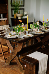 serving the table with fresh flowers and candles