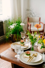 serving the table with fresh flowers and candles