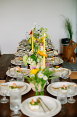 serving the table with fresh flowers and candles