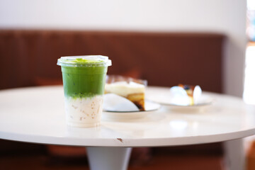Glass of ice matcha green tea on table.