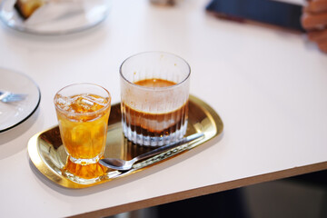 glass of dirty coffee on table at cafe.