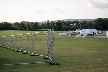 Temporary metal fence installed at Cowdray, July 2023