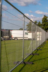 Obraz premium Temporary metal fence installed at Cowdray, July 2023