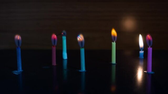 Colored candles burn in timelapse