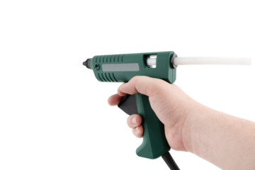 Glue gun on a white background. Electric glue gun close-up on a white background