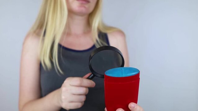 Antiperspirant containing aluminum chloride. Sweat gland blocker. Deodorant containing toxic agent. Aluminum chlorohydrate, alcohol, parabens, propylene glycol. Girl applying antiperspirant her armpit