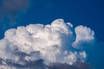 Naklejka na ściany i meble big white cumulus clouds on the blue sky