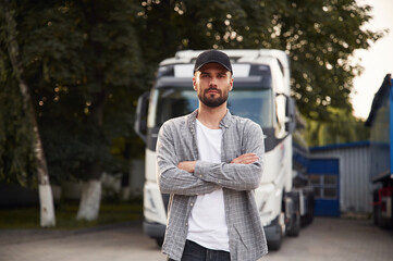 Handsome and young truck driver in casual clothes