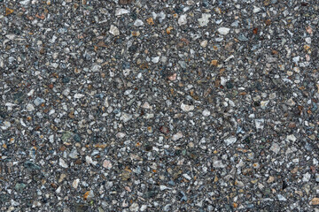 street surface texture with asphalt and small stones of a town road