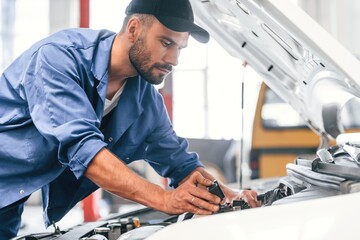 Auto mechanic working in garage. Repair service