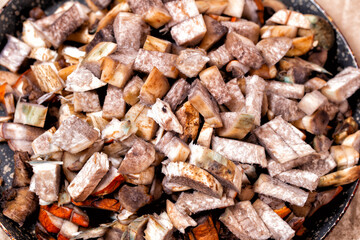 Raw chopped mushrooms in a frying pan. Close-up