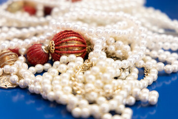 pearl necklace resting on a blue background