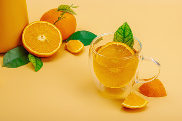 Orange tea in ceramic tea pot with ripe fruits. Refreshment seasonal drink, conceptual background