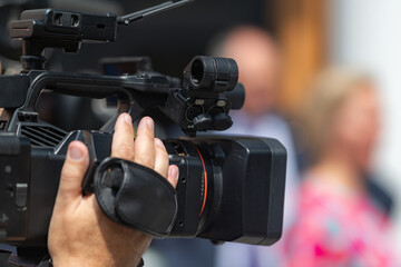 TV camera records a press conference, providing comprehensive media coverage and capturing...
