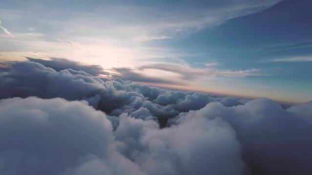 Flight between the clouds, first-person view of the aircraft during the flight at sunset. Planning between cloud clusters. aerial view