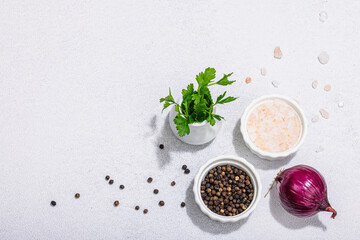 Kitchen cooking background with black peppercorn, purple onion, fresh parsley and sea salt