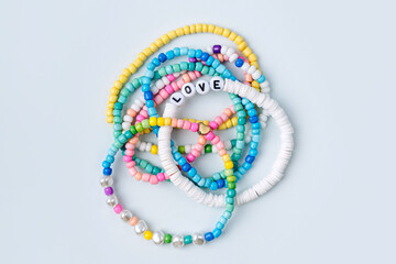 Kids handmade beaded jewelry. Necklaces and bracelets made from multicolored beads and pearls. DIY...