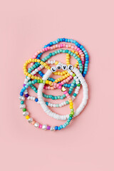 Kids handmade beaded jewelry. Necklaces and bracelets made from multicolored beads and pearls. DIY...