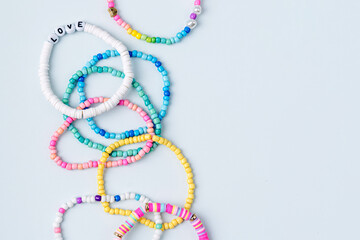 Kids handmade beaded jewelry. Necklaces and bracelets made from multicolored beads and pearls. DIY bracelet beads. Children's needlework. Creativity and hobby. Art activity for kids