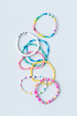 Kids handmade beaded jewelry. Necklaces and bracelets made from multicolored beads and pearls. DIY bracelet beads. Children's needlework. Creativity and hobby. Art activity for kids