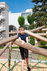 Boy goes in for sports in the rope park