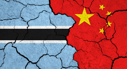 Flags of Botswana and China on cracked surface - politics, relationship concept