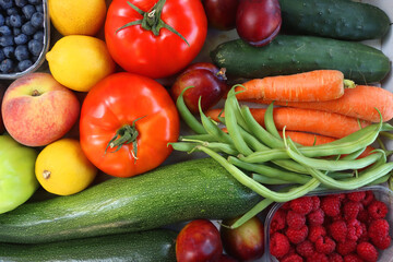 Wooden crate full of healthy colorful seasonal fruit and vegetable. Top view.