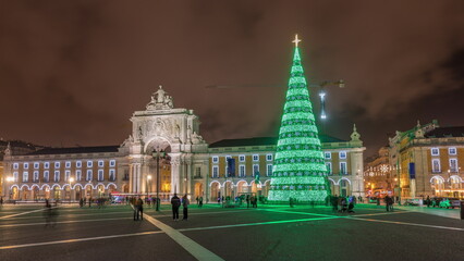 Commerce square illuminated and decorated at Christmas time in Lisbon night timelapse hyperlapse