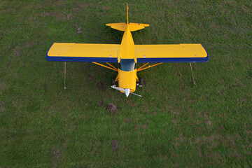 airplane carrying flying advertising banner parked on green grass