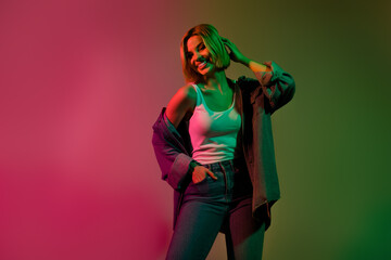 Photo of shiny pretty lady wear denim jacket smiling empty space isolated green pink gradient color background