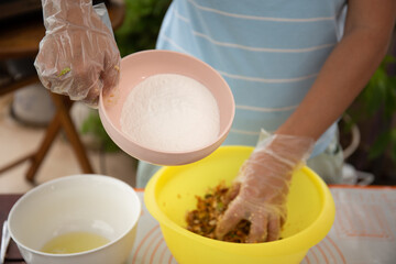 Woman prepared dough balls and salted egg yolks for making mooncakes for traditional mid autumn festival. Mooncake making process 