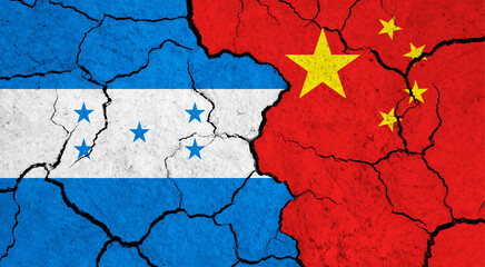 Flags of Honduras and China on cracked surface - politics, relationship concept