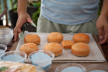 Photo of female baker packing mooncakes for sale 