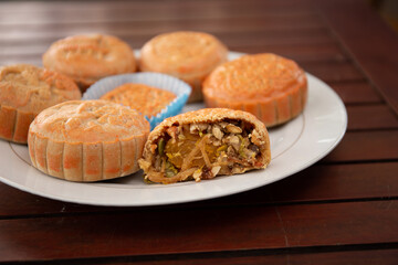 Photo of homemade mooncakes on dish on the wooden table