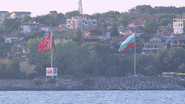 From the village of Begendik, located on Turkey's border with Bulgaria, the Bulgarian village of Rezovo, and the flags of Turkey and Bulgaria on the border are seen.