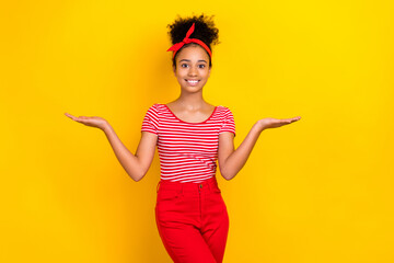 Portrait of cute little schoolgirl arms palms hold demonstrate empty space vs scales isolated on...
